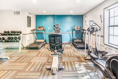 Fitness center with exercise equipment and free weights.